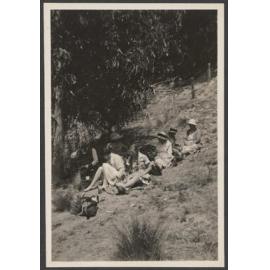 Group of people sitting under a tree