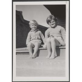 Two of the Thompson children on a step
