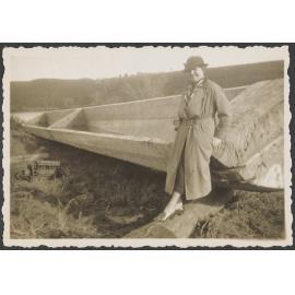 Woman leaning on a wooden boat