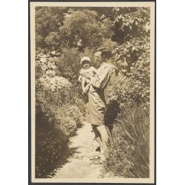 Man in a garden with a baby