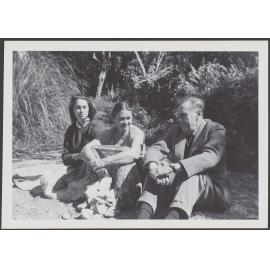 [? Garland], Peggy Garland, and Patrick White, sitting outside
