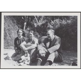 [? Garland], Peggy Garland, and Patrick White, sitting outside