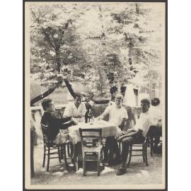 Unidentified men dining outdoors