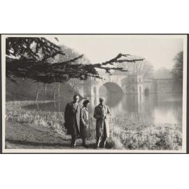 Three people walking lakeside at Blenheim Palace