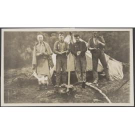Four men outside tent