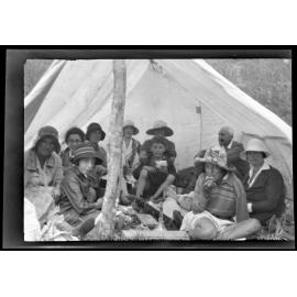 Picnic group under canvas