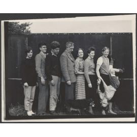 Family photograph of eight people and a dog