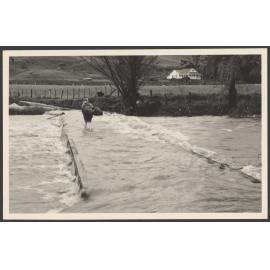 Person crossing a fast flowing river