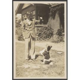 Young man playing with a dog