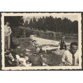 Group of people eating by lake