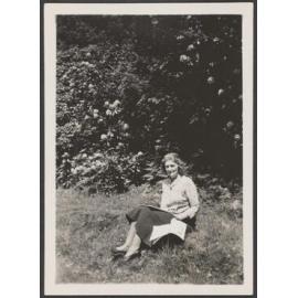 Woman on grassy bank with book [Mrs Lister-Kaye]