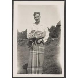Man with blanket wrapped around waist and legs
