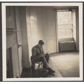 Man reading a book in an unfurnished room [Roger Cox]