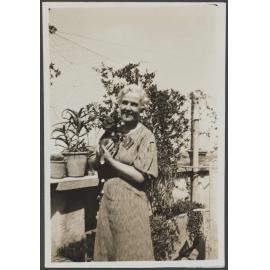 Unidentified woman holding a dog