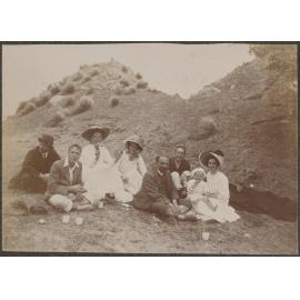 Family picnic on a bank with tussocks