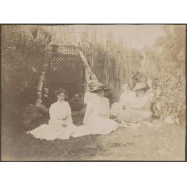Family sitting outside by gate
