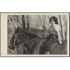 Unidentified child on a horse 