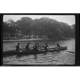 Young women rowing with crowd and trees in background [Girl Guides?]