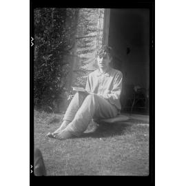 Unidentified man sitting on a doorstep