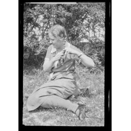 Unidentified woman plaiting her hair