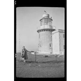 Woman standing in front of a lighthouse