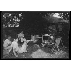 Group of five in garden, including Charles Brasch, Dora de Beer, and Willi Fels