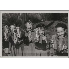 Brownies holding packets of Girl Guide Biscuits
