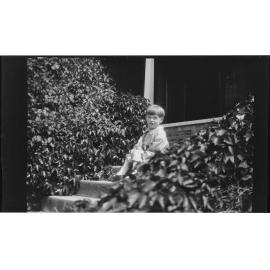 Boy sitting on steps at Manono