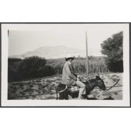 Charles Brasch riding a donkey in the Valley of the Kings