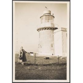 Woman standing in front of a lighthouse