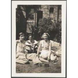 Charles, Jack and Edith Bennett sitting in a backyard