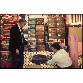 Two men with Cadbury display stand