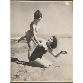 Two young women on Waimairi Beach with Cadbury Dairy Milk chocolate