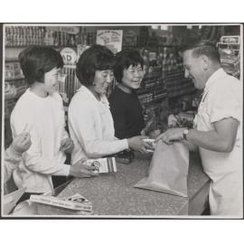 Members of the Japanese Women's Badminton Team purchasing Cadbury products