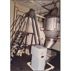 McIntyre Machine. Powder weighing hopper and Floveyor loading.