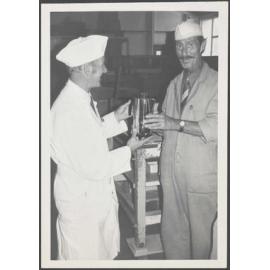 Arch McQuarrie presenting Wilf Stanton a gift from his fellow workers