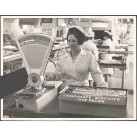 Raelene O'Neill packing chocolate biscuits for export to Australia