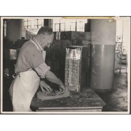 Man wrapping product at Cadbury Fry Hudson factory