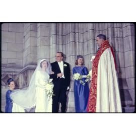 Elizabeth Walsh with her father Sir John Walsh, bridal party, and minister, on her wedding day
