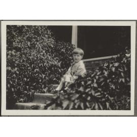 Unidentified boy sitting on steps