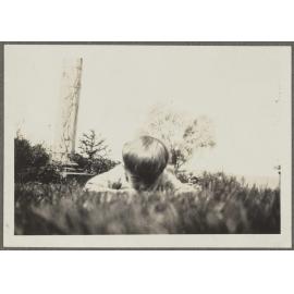 Boy lying in grass