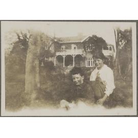 Two unidentified children with house in background