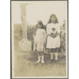 Unidentified girl and Lesley Brasch holding a doll