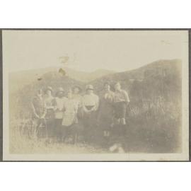 Eight unidentified people among grass hills