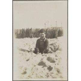 Unidentified child sitting in sand