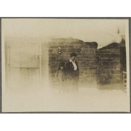 [Lesley Brasch and Jane McCartney] standing in front of stone building