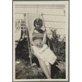 Unidentified woman sitting in chair