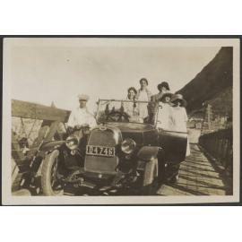 Henry and Lesley Brasch and four unidentified women sitting in a car on bridge