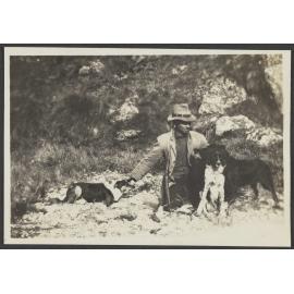 Unidentified man with a gun and two dogs