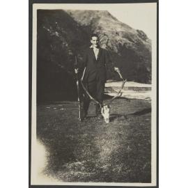 Unidentified man with deer antlers and gun